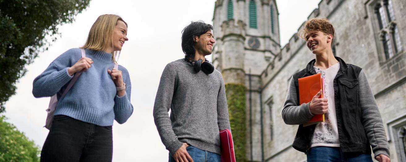 3 students walking through campus